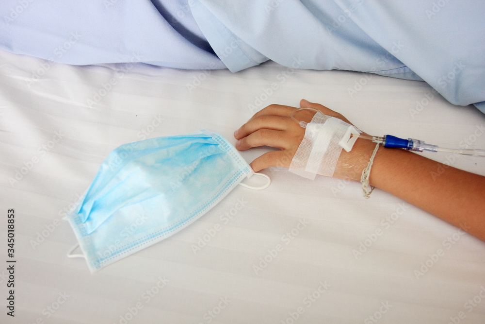 Fototapeta premium Close up child hand saline intravenous. Baby admitted at hospital. Health care and Medical equipment concept.