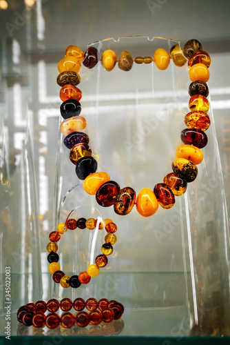 Amber neklace and bracelet on a glass shelf photo