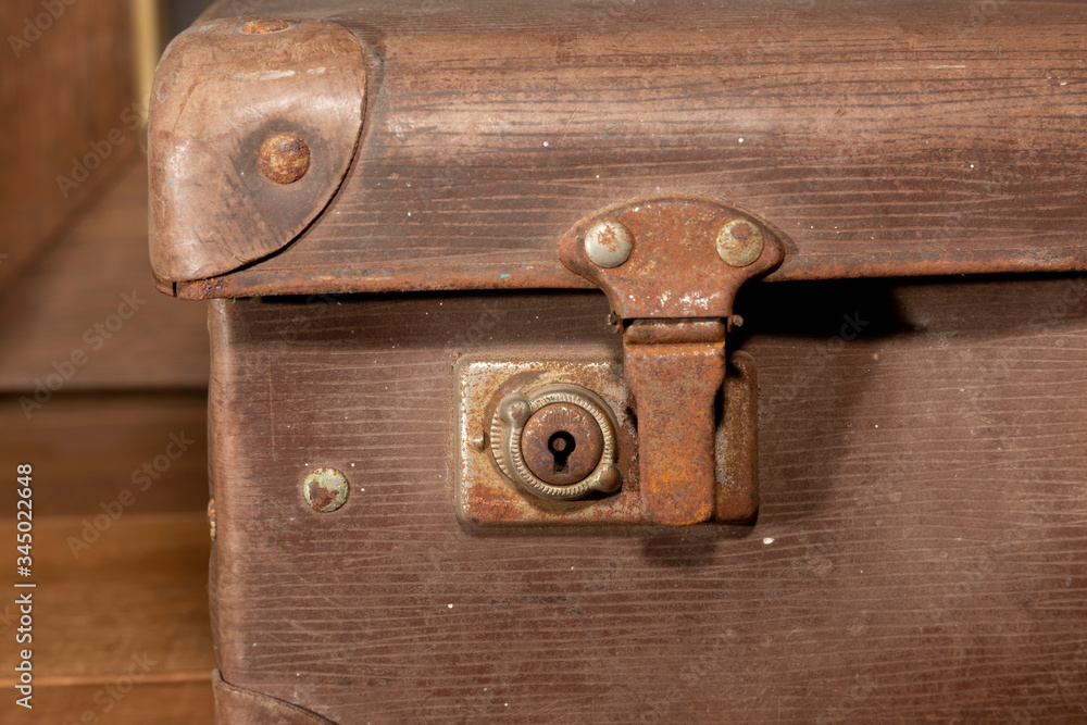 A rusty lock on an old brown leather suitcase A rusty lock on an old brown leather suitcase