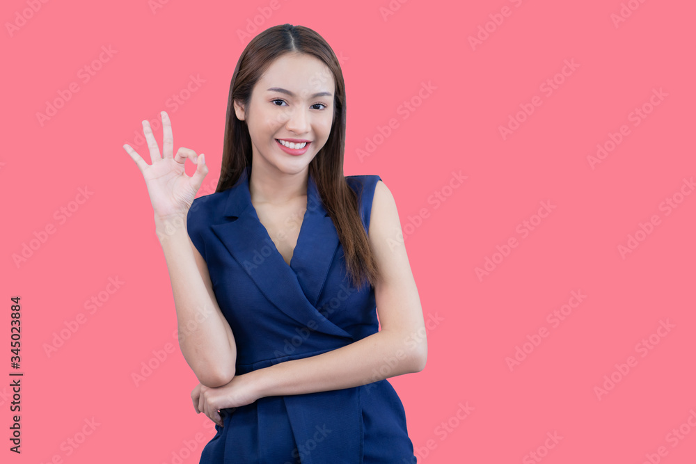 Fototapeta premium Portrait of beautiful woman in pink background.