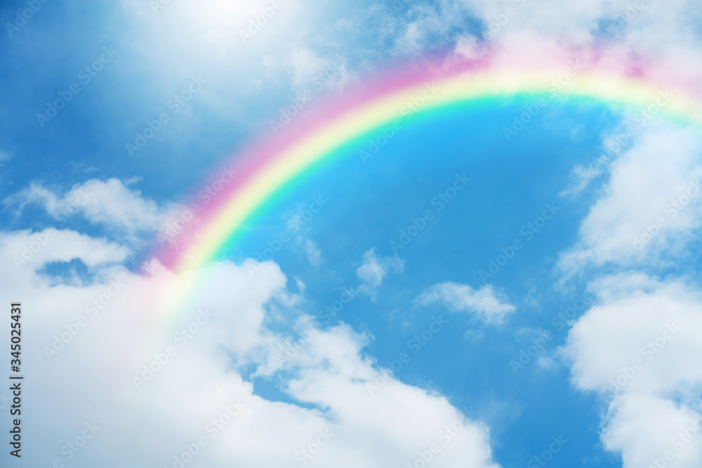 Rainbow in blue sky.