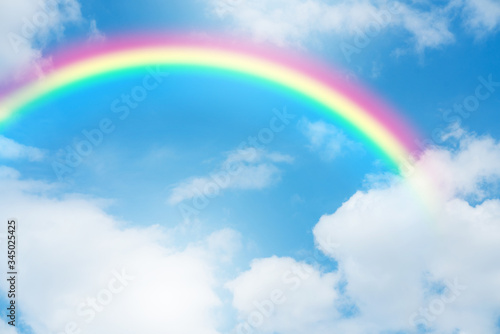 Rainbow in blue sky.
