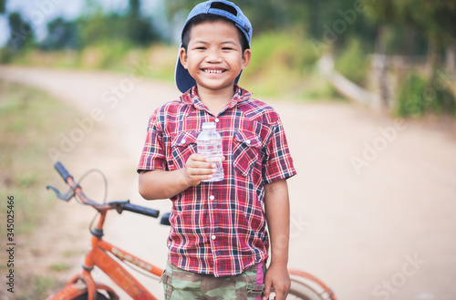 Little boy drinking water bottle.