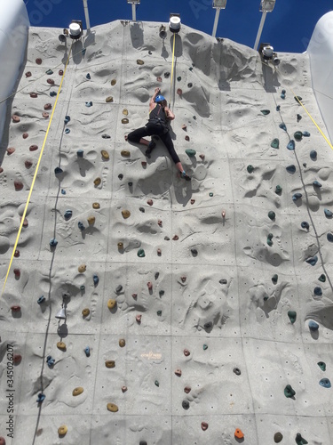 Woman on rock climbing wall on cruise ship