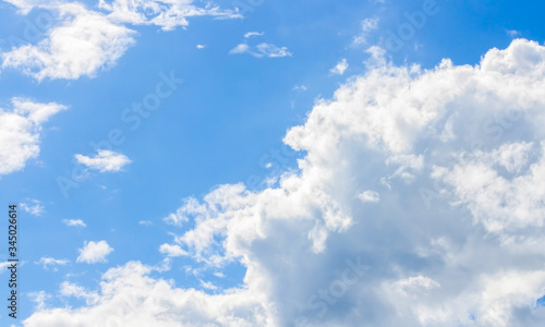 White light with fluffy clouds in blue sky
