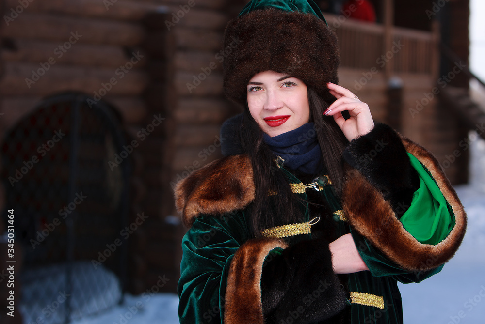 brunette girl in medieval russian costume outdoor with wooden vintage building on background