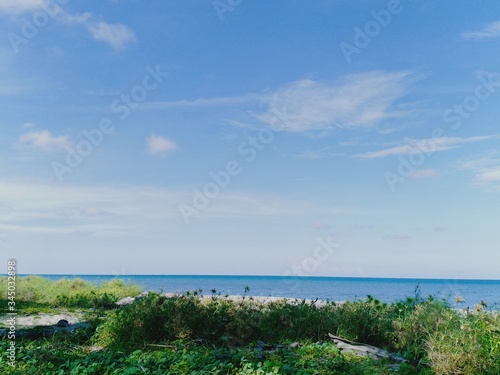 blue sea with blue sky background © adehan