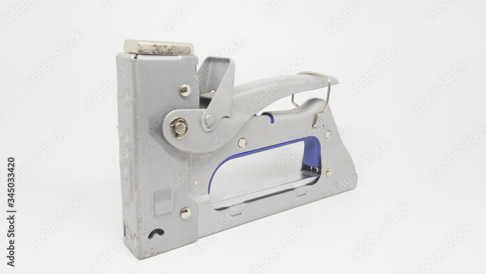 Metalic Carpentry Stepler for Stapling Books Documents Receipts of Office Equipment Tools in White Isolated Background Metalic Carpentry Stepler for Stapling Books Documents Receipts of Office Equipment Tools in White Isolated Background