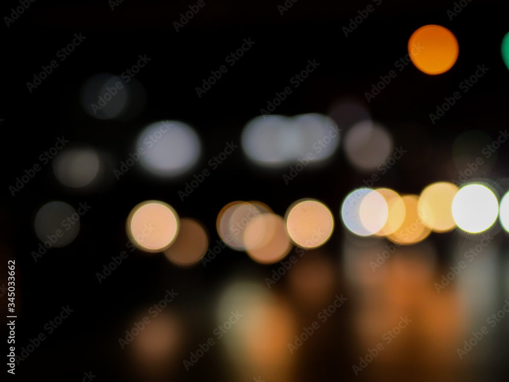 Abstract of blurred photo of light bokeh on the dark background Abstract of blurred photo of light bokeh on the dark background
