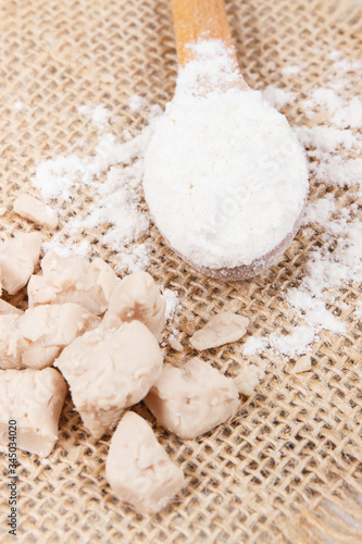 Fresh crumbled yeast and flour on spoon for baking different dough or bread