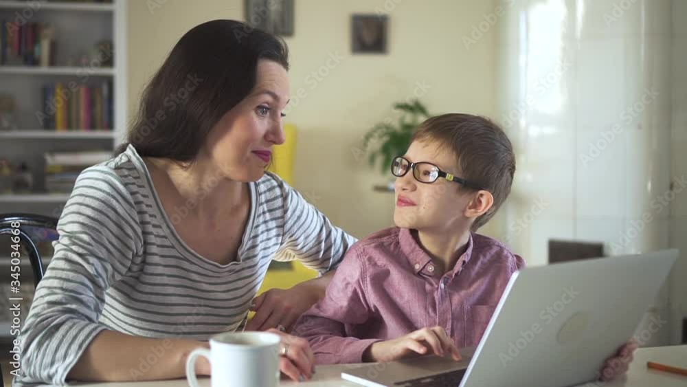 happy middle age mom and son chattig on laptop with relatives or dad. Spbd laughing mother and boy family typing on computer. kid learning to use computer. concept chatting, quarantine happy middle age mom and son chattig on laptop with relatives or dad. Spbd laughing mother and boy family typing on computer. kid learning to use computer. concept chatting, quarantine