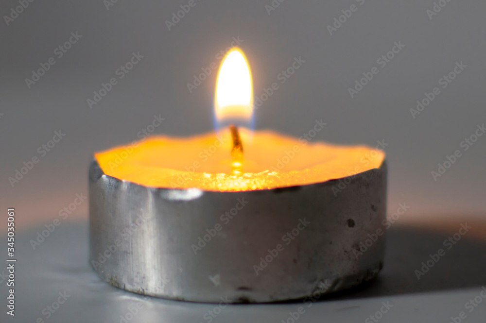 A wax lamp burns brightly on the white surface A wax lamp burns brightly on the white surface