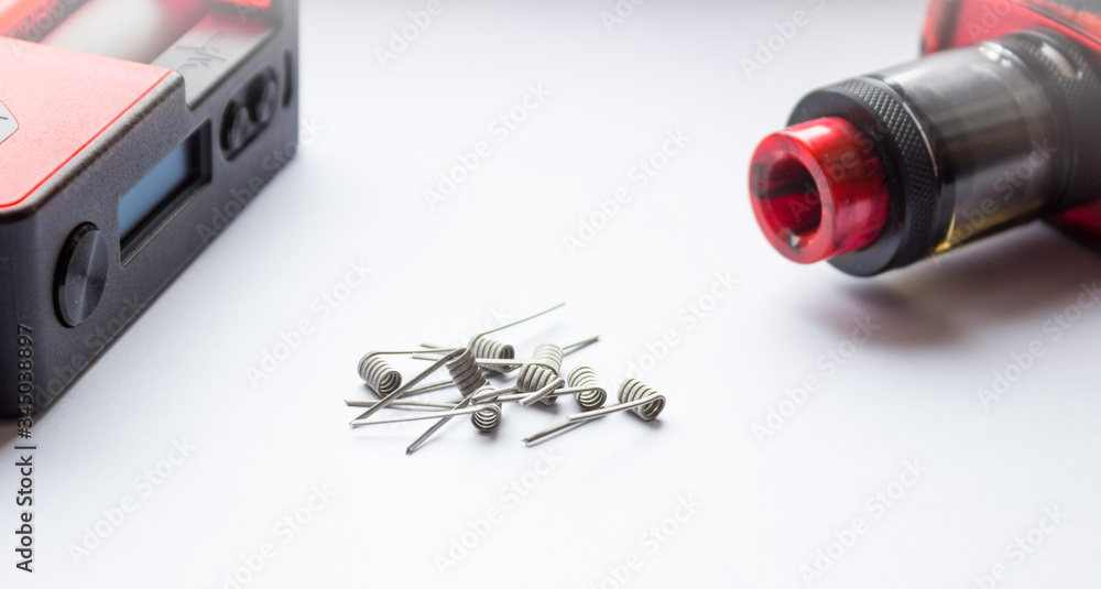 E-cigarette coils on a white background. Metal components for VAPE, consumables. Part of the VAPE on the side E-cigarette coils on a white background. Metal components for VAPE, consumables. Part of the VAPE on the side