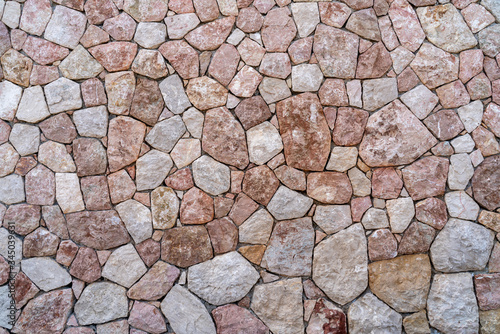 seamless stone wall made of natural stone, background and texture