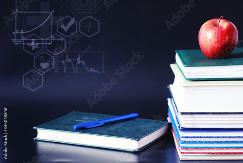 A stack of textbooks and books on the table. The concept of knowledge. photo