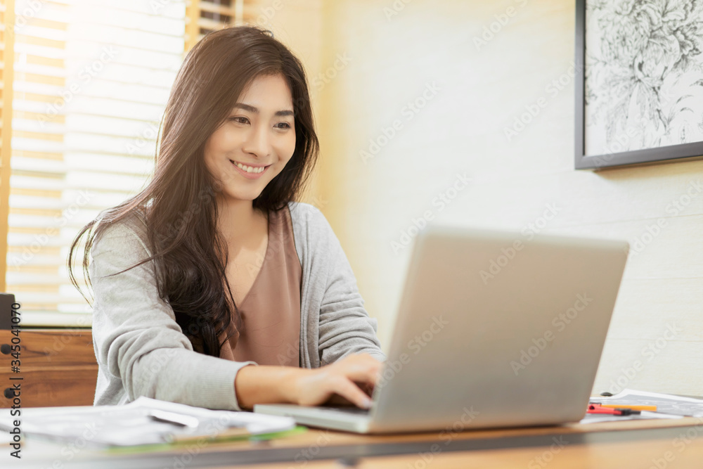 Asian beautiful woman smiling using computer laptop typing innovative ideas, in video call conference meetings with collogues discussing work planning strategy ecommerce during quarantines isolation