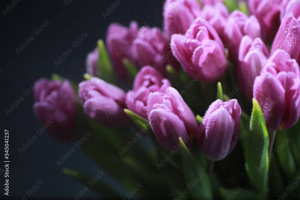 Obraz premium Bouquet of fresh flowers. Holiday gift to your loved one. Background St. Valentine's Day. Rose, tulip, iris flower arrangement.