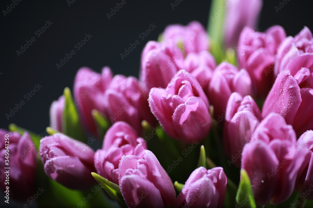Obraz premium Bouquet of fresh flowers. Holiday gift to your loved one. Background St. Valentine's Day. Rose, tulip, iris flower arrangement.