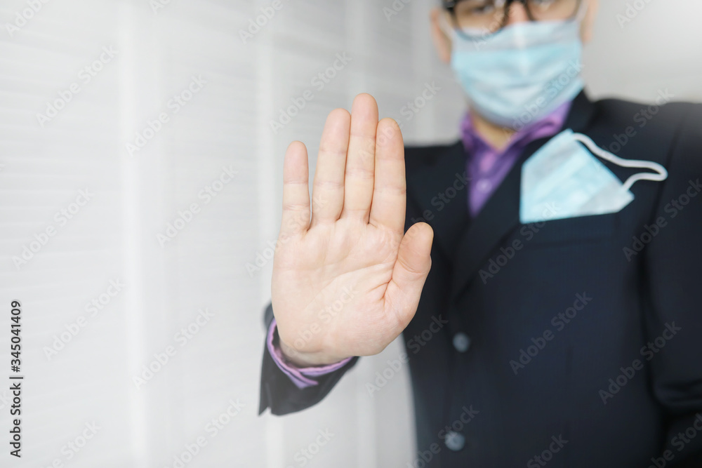 A disposable medical mask sticks out of a pocket instead of a napkin. A man with a disposable mask in a suit and jeans. Individual respiratory protection. A disposable medical mask sticks out of a pocket instead of a napkin. A man with a disposable mask in a suit and jeans. Individual respiratory protection.