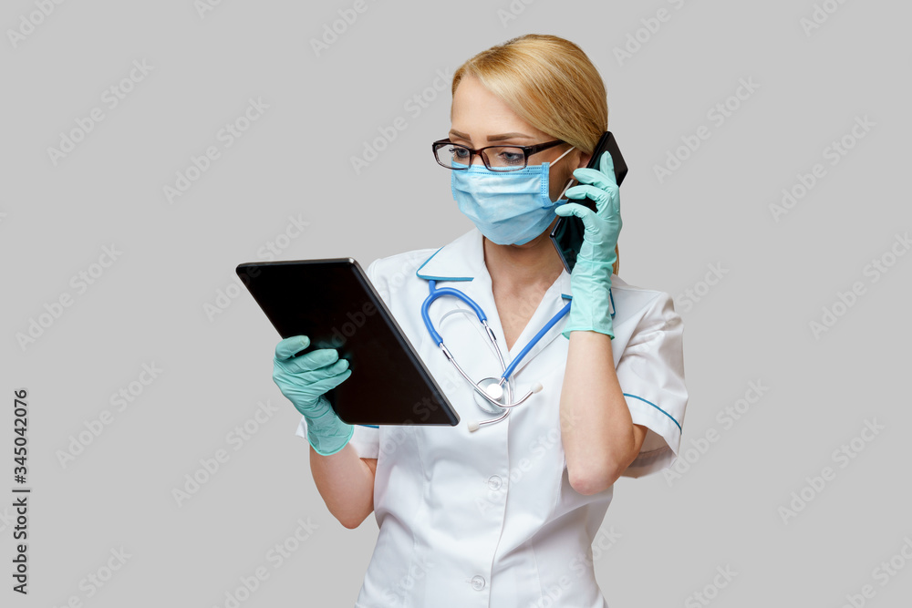 medical doctor nurse woman wearing protective mask and gloves - holding tablet pc and mobile phone medical doctor nurse woman wearing protective mask and gloves - holding tablet pc and mobile phone