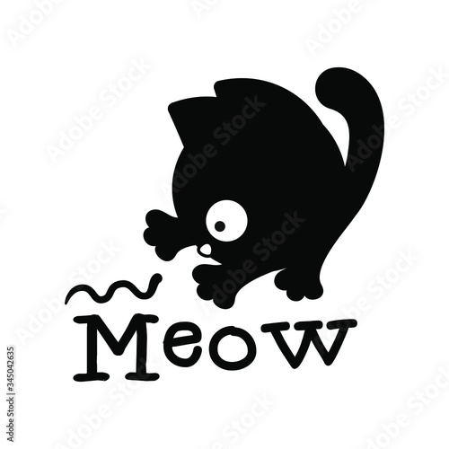 Funny black kitten playing with a worm with 