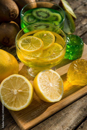 Fresh kiwi jelly and lemon jelly on old wooden background. Tasty healthy vegetarian dessert sugar free. 