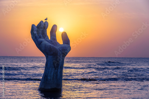 Sunrise at the giant hand at Homigot Beach, Pohang, South Korea. 8 February 2019