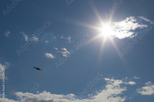 closeup drone flying over blue sky with sparkle sun