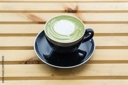 Matcha Latte in a cup on a wooden background, product photography