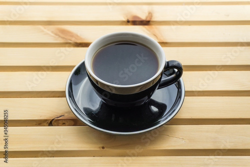 Cappuccino in a cup on a wooden background, product photography