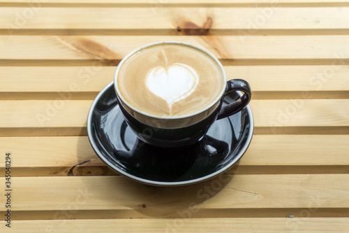 Cappuccino in a cup on a wooden background, product photography