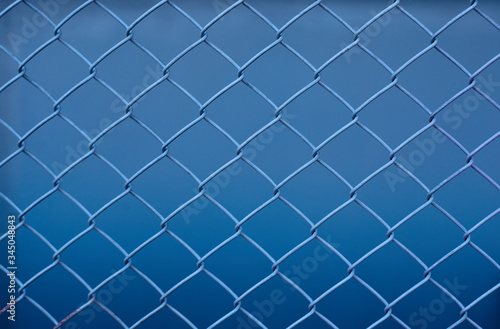 metal mesh on a blue background  abstraction  woven metal mesh pattern