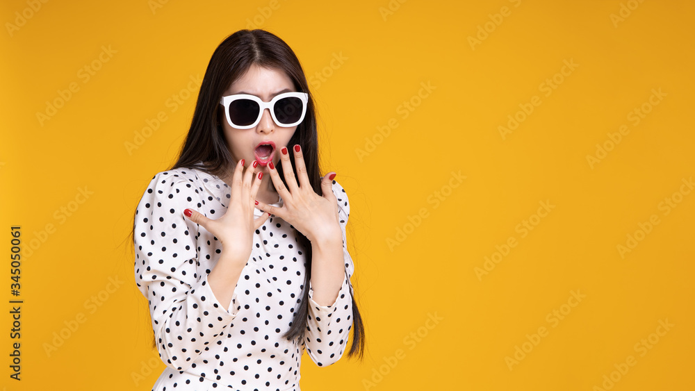 Fototapeta premium Asian woman in summer casual clothes.She smiling and happy shopping. she lovely attractive shine on yellow background.Summer Surprise Sale concept.