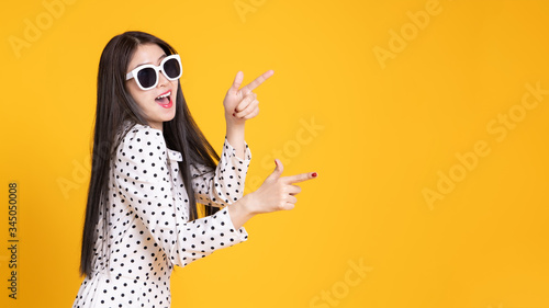 Asian woman in summer casual clothes.She smiling and happy shopping. she lovely attractive shine on yellow background.Summer Surprise Sale concept.