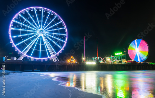 steel pier with reflection at night Atlantic city new jersey usa.