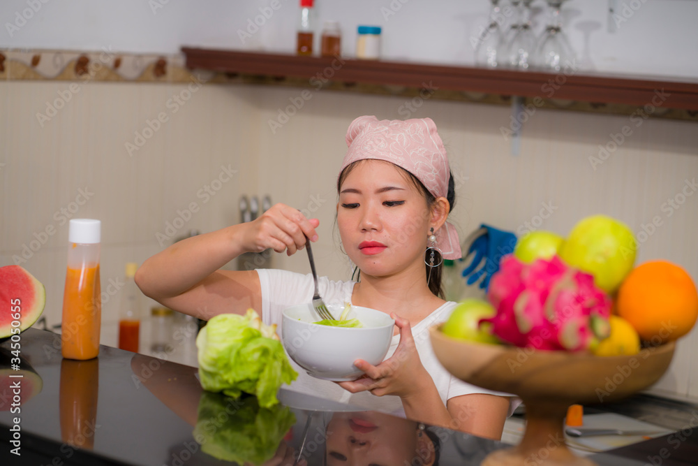 vegetable food and diet - home lifestyle portrait of young beautiful and happy Asian Chinese woman at domestic kitchen smiling cheerful in healthy nutrition and dieting concept vegetable food and diet - home lifestyle portrait of young beautiful and happy Asian Chinese woman at domestic kitchen smiling cheerful in healthy nutrition and dieting concept