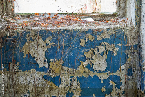 Old blue painted wall in abandoned building. 