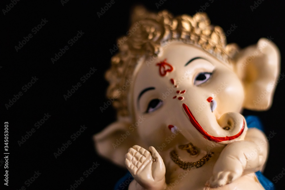 low angle macro close up shot of beautiful ganesha statue on the black background. wisdom concept low angle macro close up shot of beautiful ganesha statue on the black background. wisdom concept