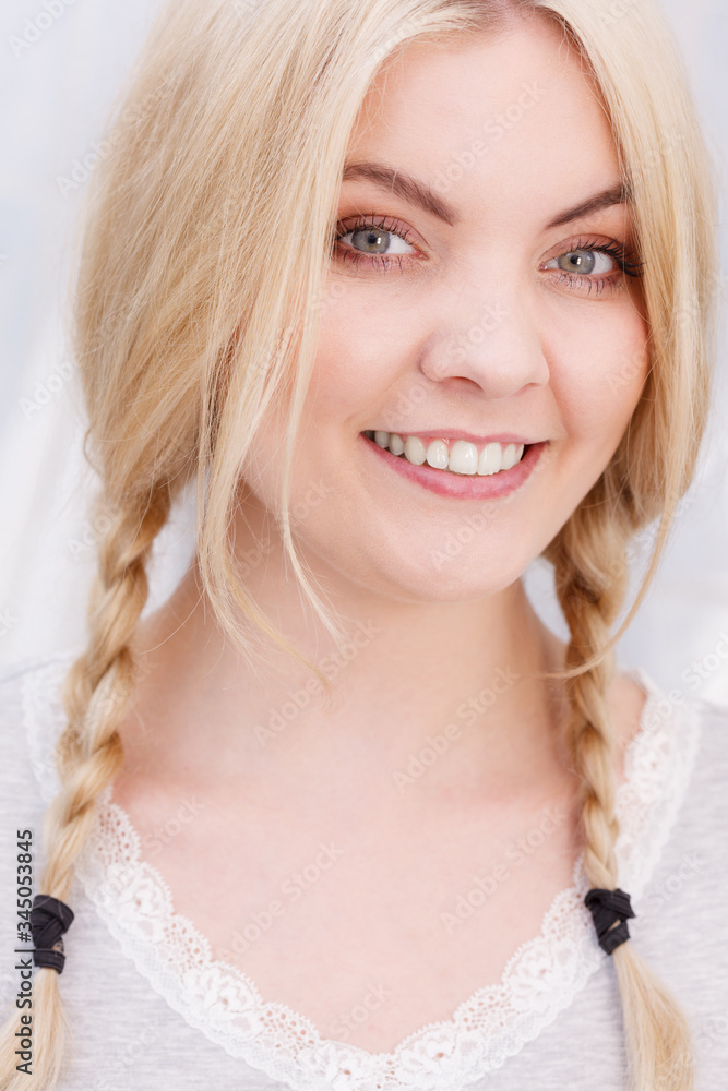Happy woman having braided blonde hair