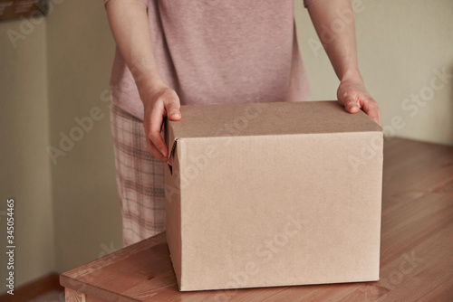 close-up of a woman's hand opening a parcel © Максим Корабельщиков