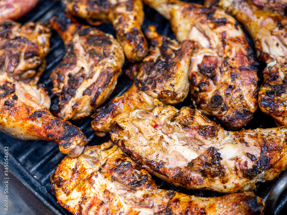 delicious chicken legs cooking on grill close up photo