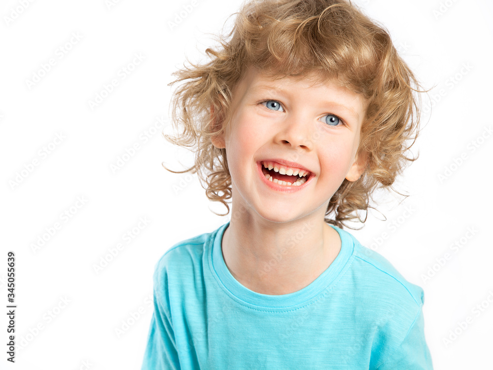 Portrait of a happy child. A curly-haired European boy on a white background laughs merrily. Violent emotions, celebration. A dream come true. Portrait of a happy child. A curly-haired European boy on a white background laughs merrily. Violent emotions, celebration. A dream come true.