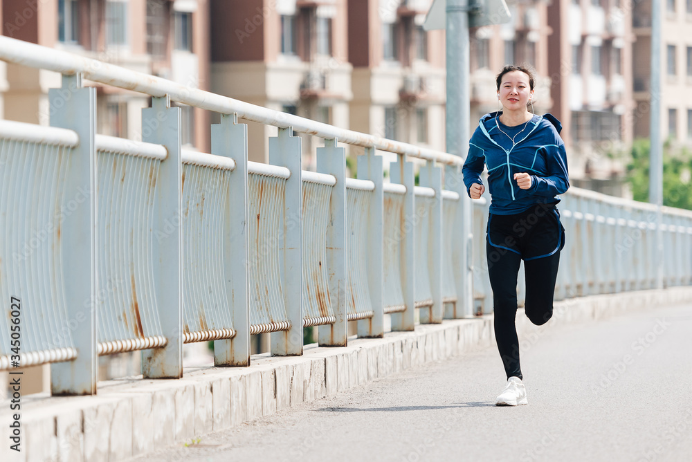 A young Asian Chinese woman is running