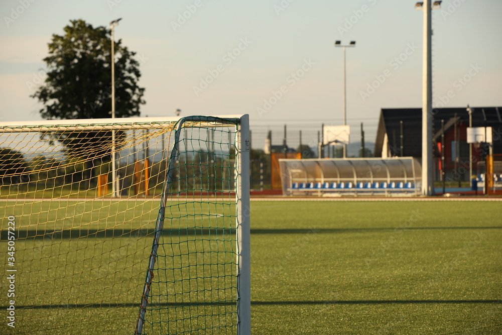 Fototapeta premium Jaslo, Poland - 7 9 2019: Goal on a football field with natural green grass in the open stadium of the city. A place for competitions and sporting events. Landscaping sports. Outdoor activities