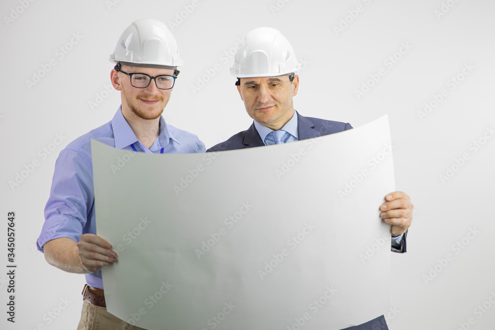 Satisfied engineer and architect working, meeting, discussing, designing, planing, measuring layout of building blueprint isolated on white background. Construction, engineering, architecture concept Satisfied engineer and architect working, meeting, discussing, designing, planing, measuring layout of building blueprint isolated on white background. Construction, engineering, architecture concept