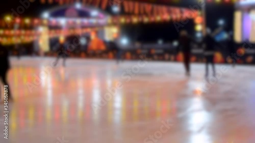 Wallpaper Mural People ride on an ice rink with luminous glowing yellow-red garland lamp. Torontodigital.ca