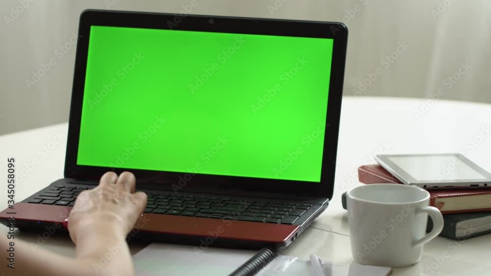 Closeup woman sitting table notebook female hands keyboarding laptop using texting pointing networking green screen chroma key chromakey keyboard white device working message student businesswoman Closeup woman sitting table notebook female hands keyboarding laptop using texting pointing networking green screen chroma key chromakey keyboard white device working message student businesswoman