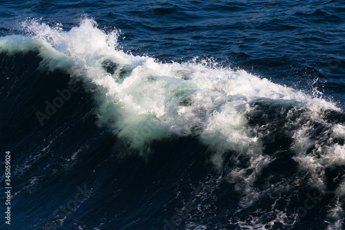 Fototapeta Naklejka Na Ścianę i Meble -  White crest of a sea wave. Selective focus. Shallow depth of field
