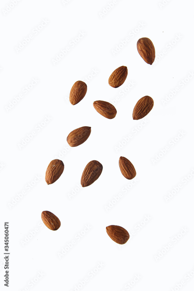 pouring almond against white background. Concept of flying food pouring almond against white background. Concept of flying food