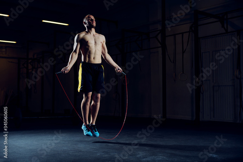 Obraz na plátně Athletic young man training with skipping rope